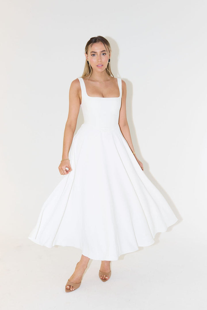 White square-neck A-line maxi dress with fitted corset-style bodice and flowing skirt