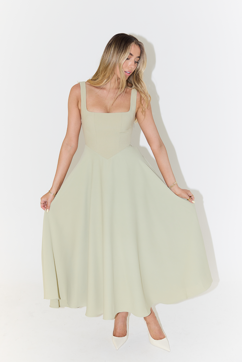 Sage green A-line maxi dress with full skirt held out to show movement