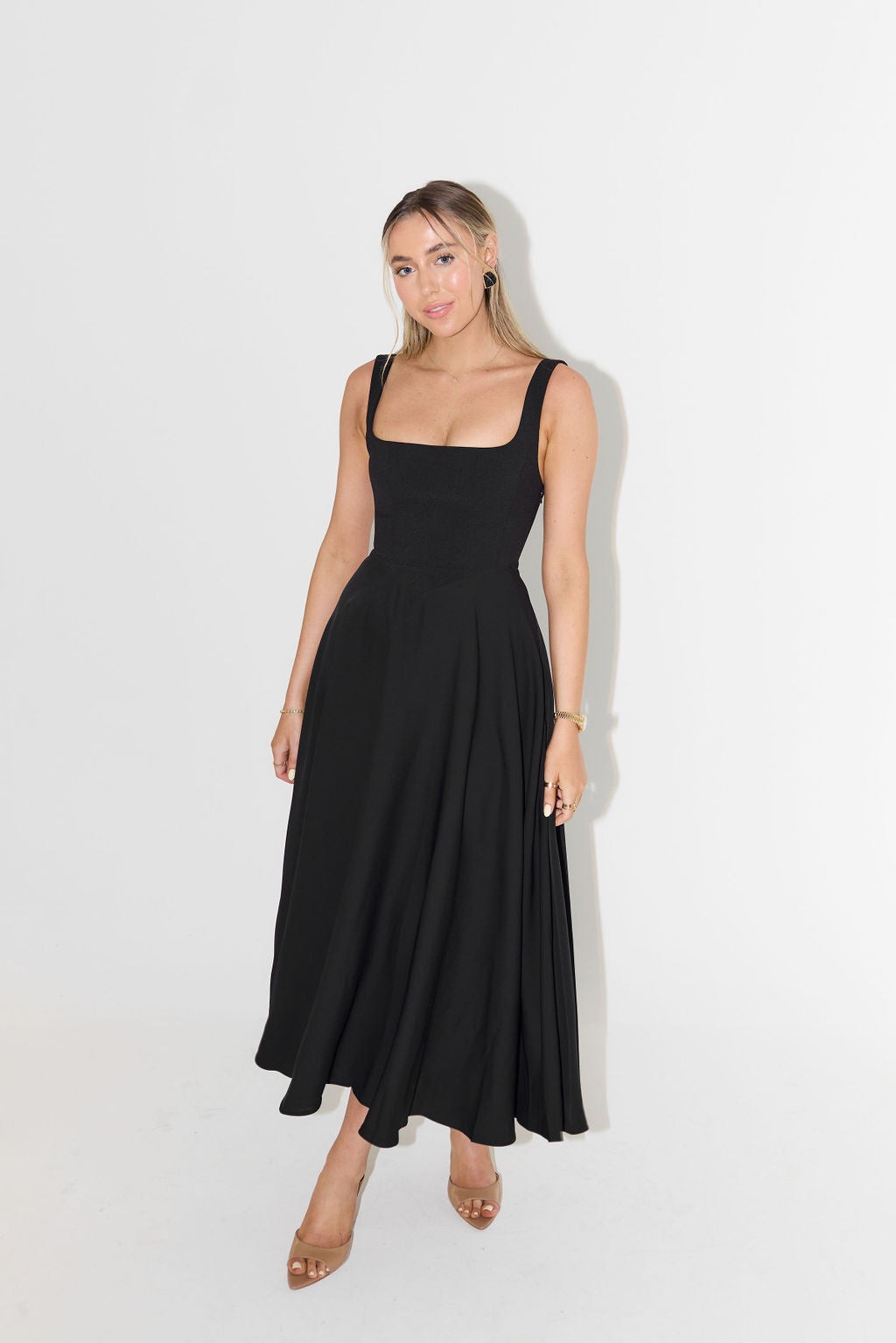 Black sleeveless A-line maxi dress with structured bodice and full swishy skirt