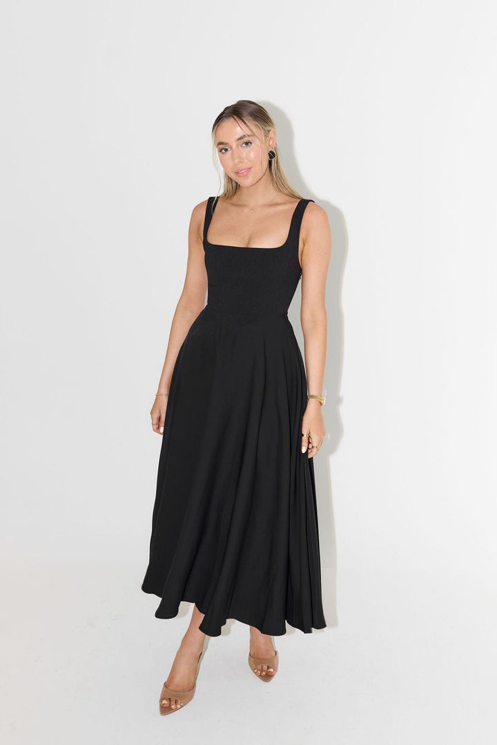 Black sleeveless A-line maxi dress with structured bodice and full swishy skirt