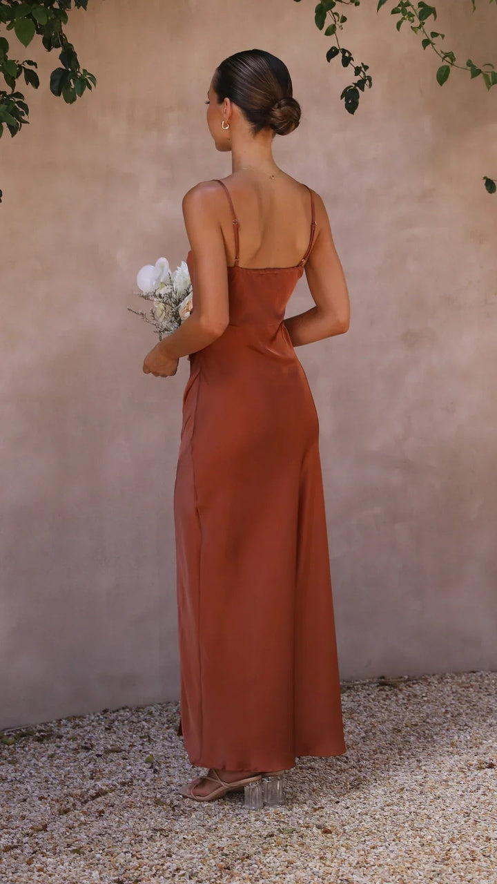 Rear view of rust satin slip dress showing adjustable straps and low back