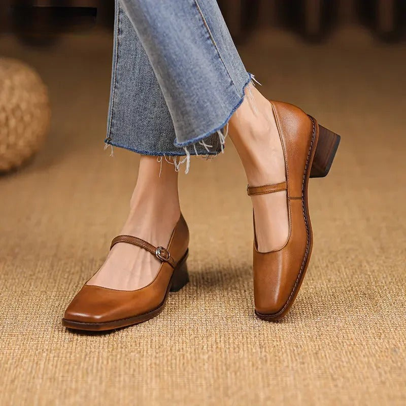 Tan leather Mary Jane shoes with block heel and buckle strap, worn with jeans