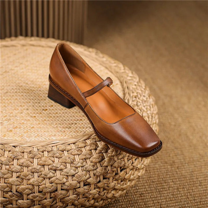 Single tan leather Mary Jane shoe showing square toe and stacked wooden heel