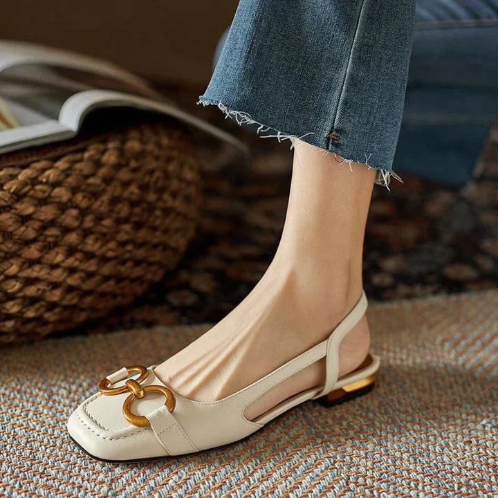 Cream leather slingback sandals with square toe and gold chain buckle
