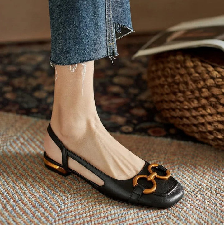 Black leather slingback flats with gold chain detail and low block heel