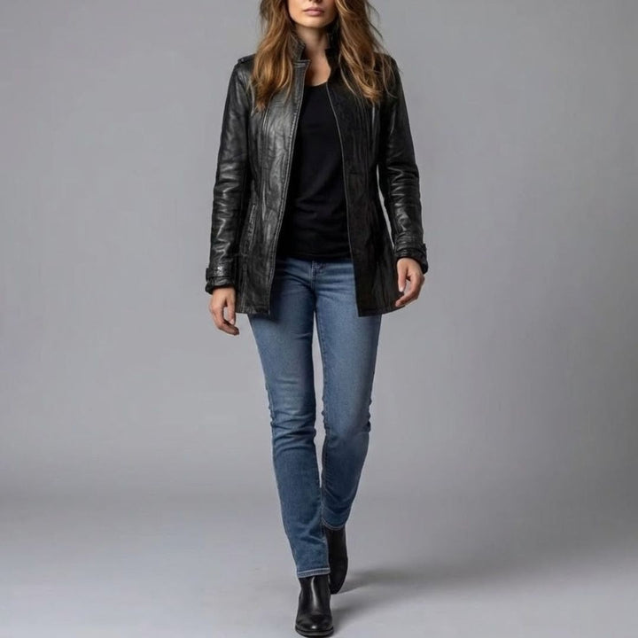 Model wears black leather tailored jacket with skinny jeans and ankle boots