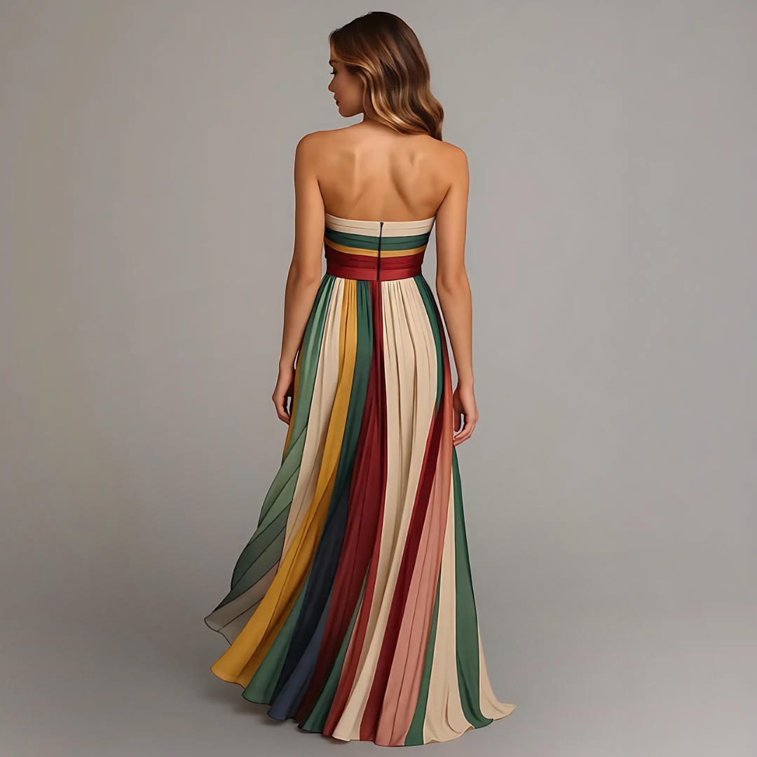 Back view of strapless striped maxi dress featuring concealed zip and cascading pleated skirt