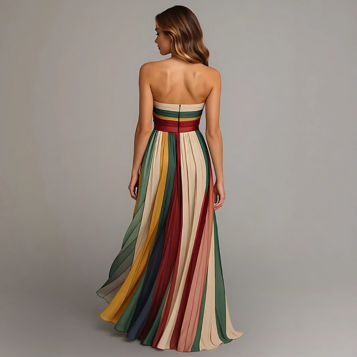 Back view of strapless striped maxi dress featuring concealed zip and cascading pleated skirt