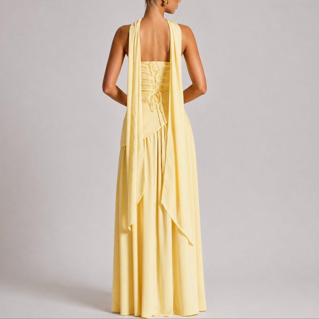 Rear view of pale yellow maxi dress showing lace-up back and draped scarf