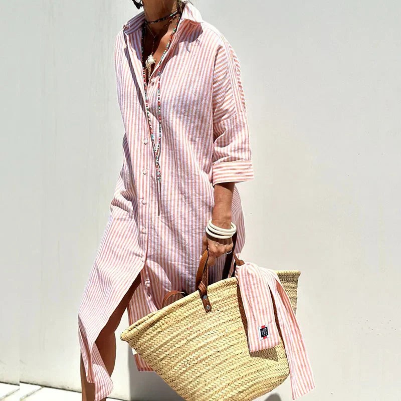 Pink striped maxi shirt dress with side split worn with woven straw bag