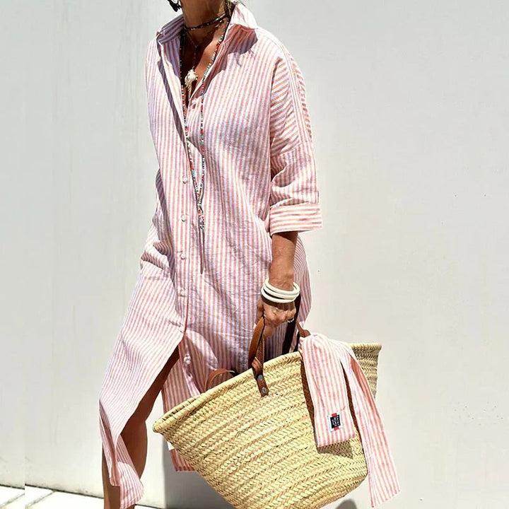 Pink striped maxi shirt dress with side split worn with woven straw bag