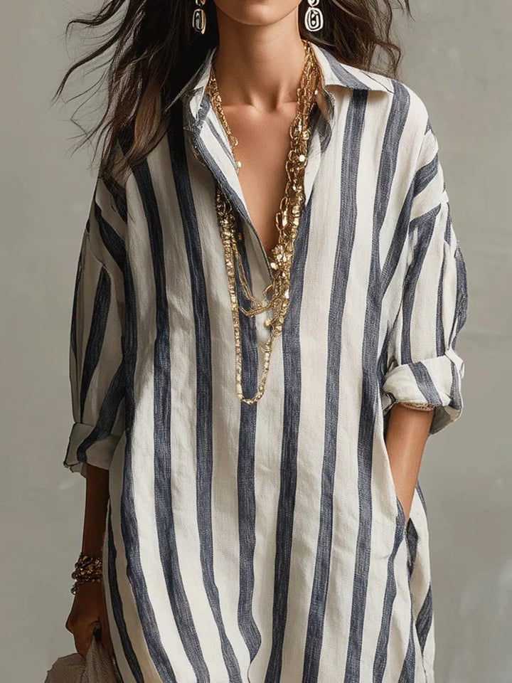 Close-up of navy striped shirt dress collar with layered gold necklaces