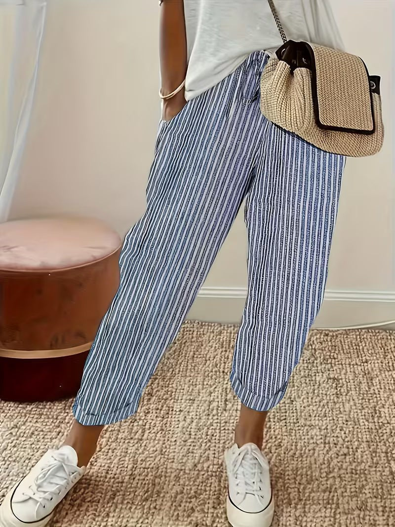 Blue striped wide-leg trousers with turn-up cuffs styled with white trainers