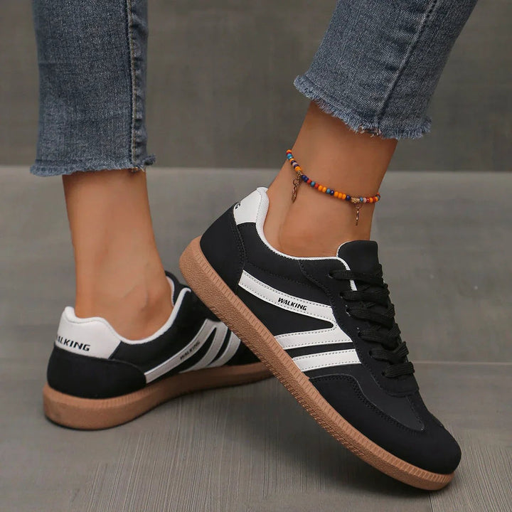 Black and white lace-up trainers with striped side panels