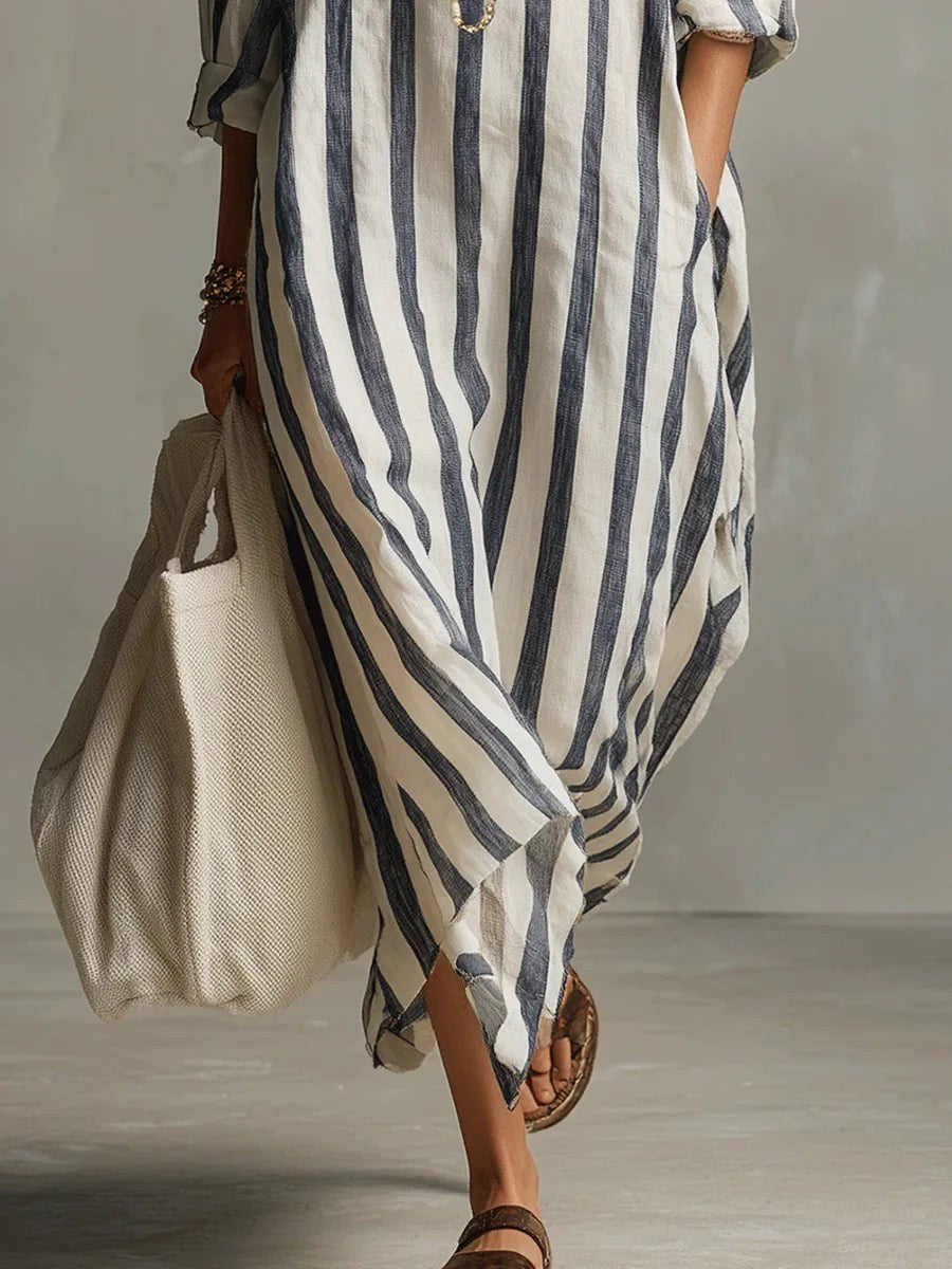 Flowing hemline detail of navy and cream striped cotton maxi dress