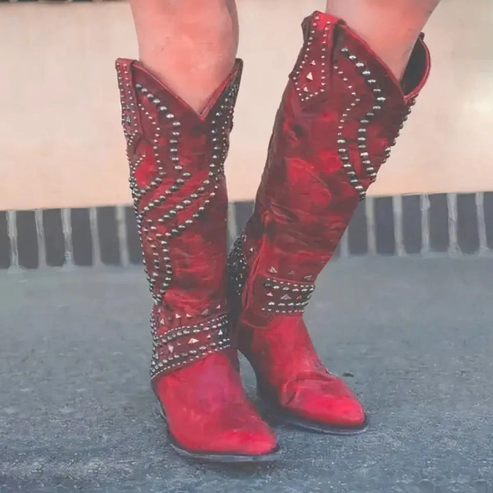 Red leather knee-high western boots adorned with diamante and studded trim detailing