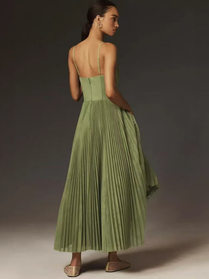 Rear view of pleated olive maxi dress showing fitted bodice and flared skirt