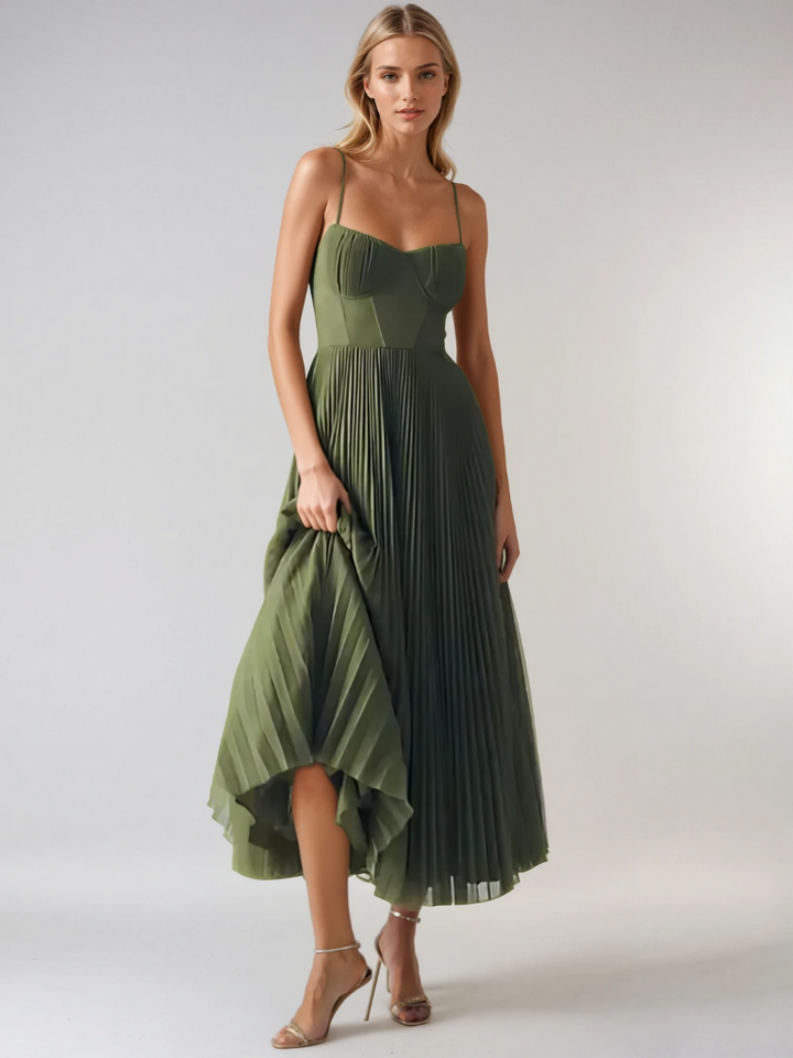 Front view of olive pleated maxi dress with high-low hem and metallic heels