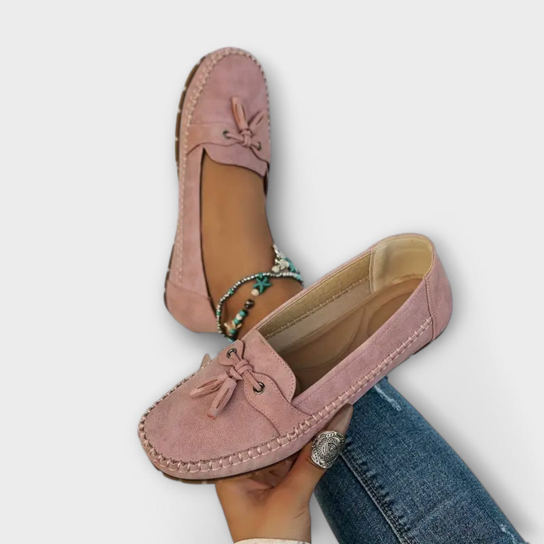 Dusky pink suede tassel loafers displayed with cushioned tan insole visible