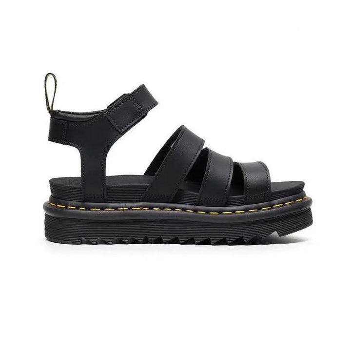 Side view of black chunky platform sandal with ridged sole and ankle strap