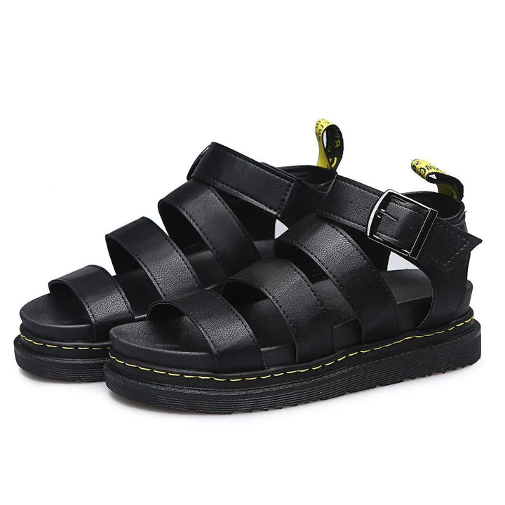 Pair of black leather triple-strap sandals with buckled ankle closure