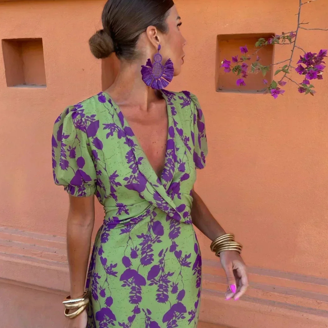 Close-up of puff-sleeve wrap dress showing plunging V-neck and purple floral print