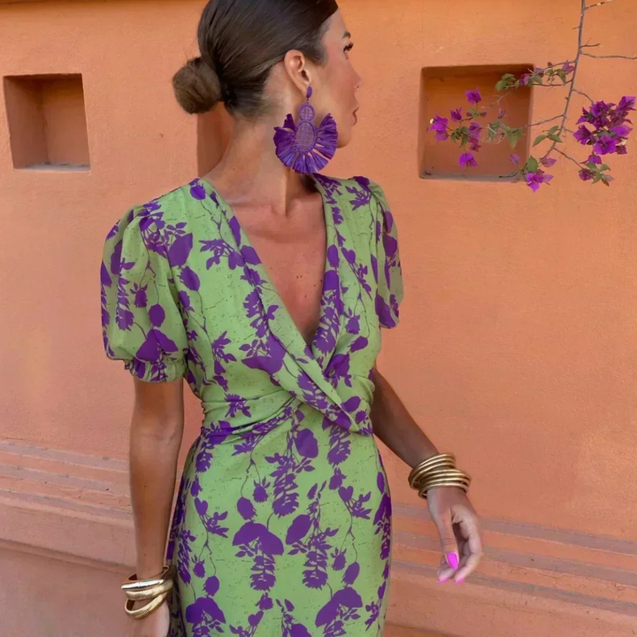Close-up of puff-sleeve wrap dress showing plunging V-neck and purple floral print