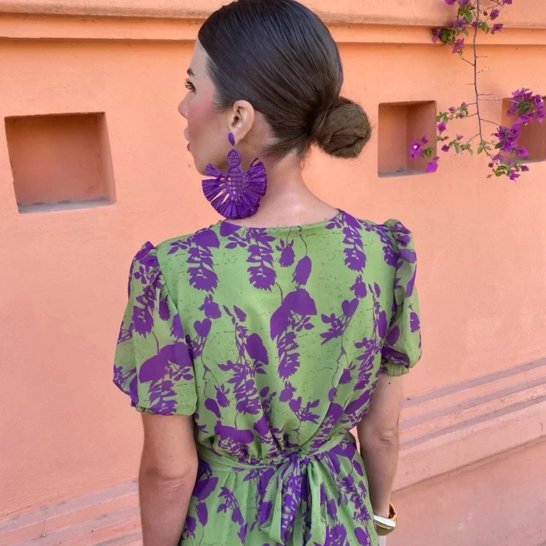 Rear view of wrap maxi dress highlighting waist tie and purple floral pattern