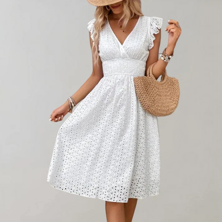 V-neck white eyelet midi dress featuring smocked waist and ruffled flutter sleeves