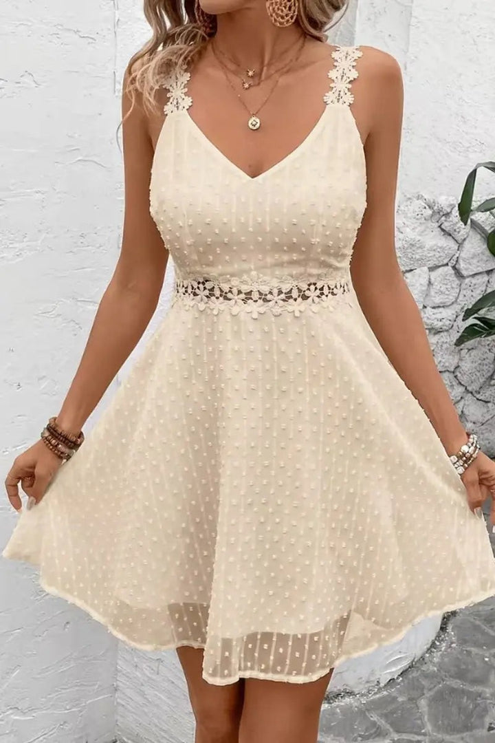 V-neck cream dress featuring crochet floral straps and Swiss dot fabric