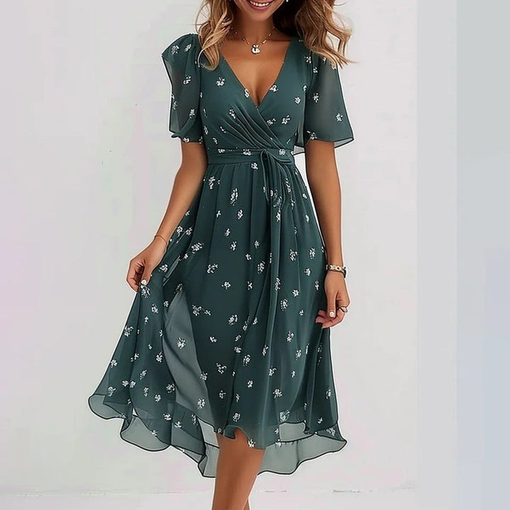 Green floral chiffon wrap dress featuring flutter sleeves and tie waist