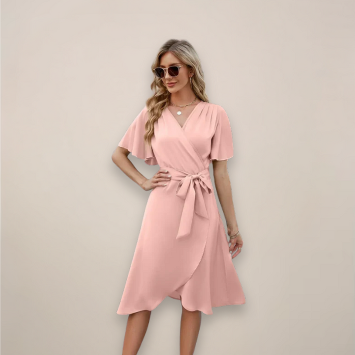 Pink wrap midi dress featuring flutter sleeves and waist tie