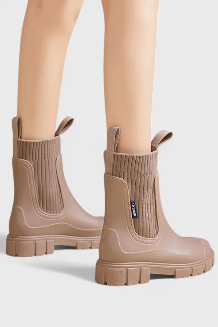 Taupe Chelsea ankle boots worn on model, rear view showing pull-tab