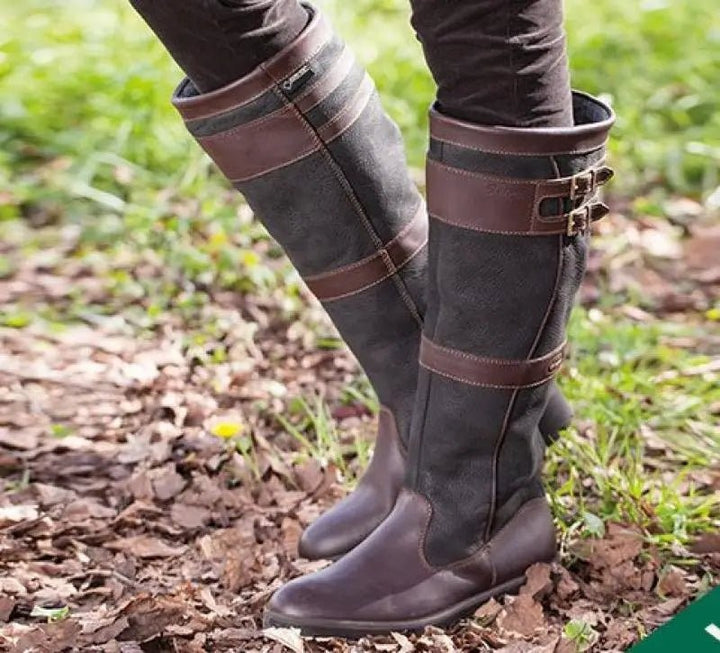 Knee-high waterproof leather boots in black and brown with buckle strap detail