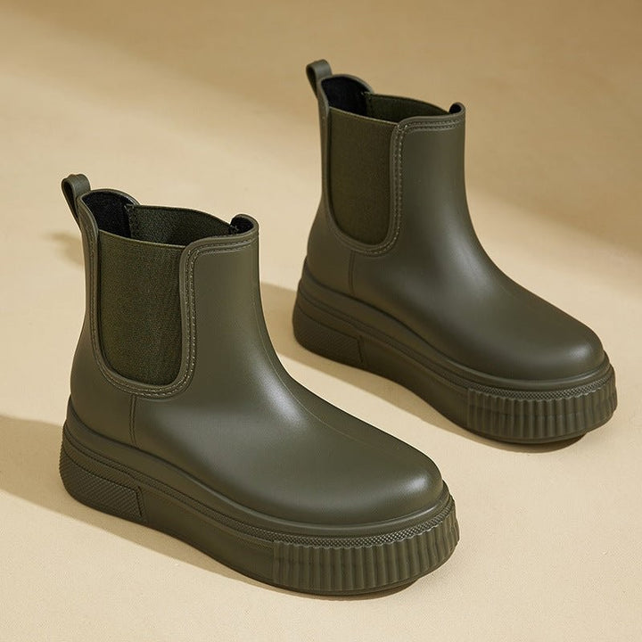 Khaki green Chelsea rain boots with chunky platform sole and elastic side panel