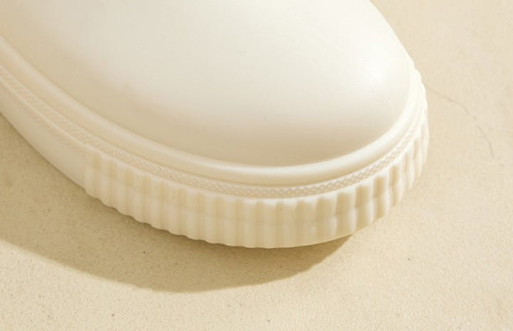 Close-up of cream platform boot toe showing ribbed rubber edging