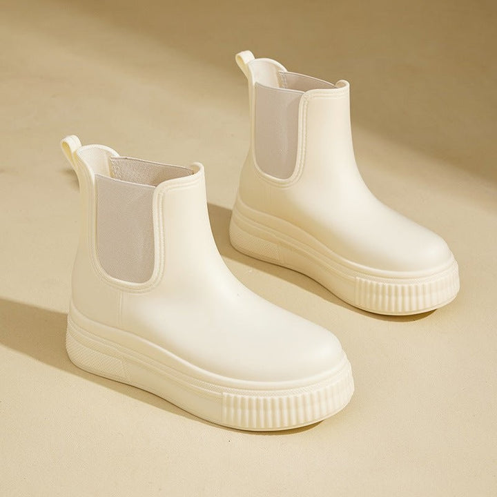 Cream Chelsea platform rain boots with ridged sole and pull-tab detail