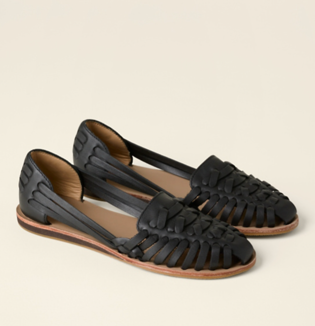 Black woven leather huarache flat sandals with closed toe design