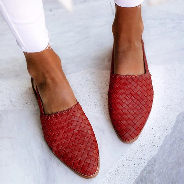 Rust red woven leather pointed-toe flat with slingback detail