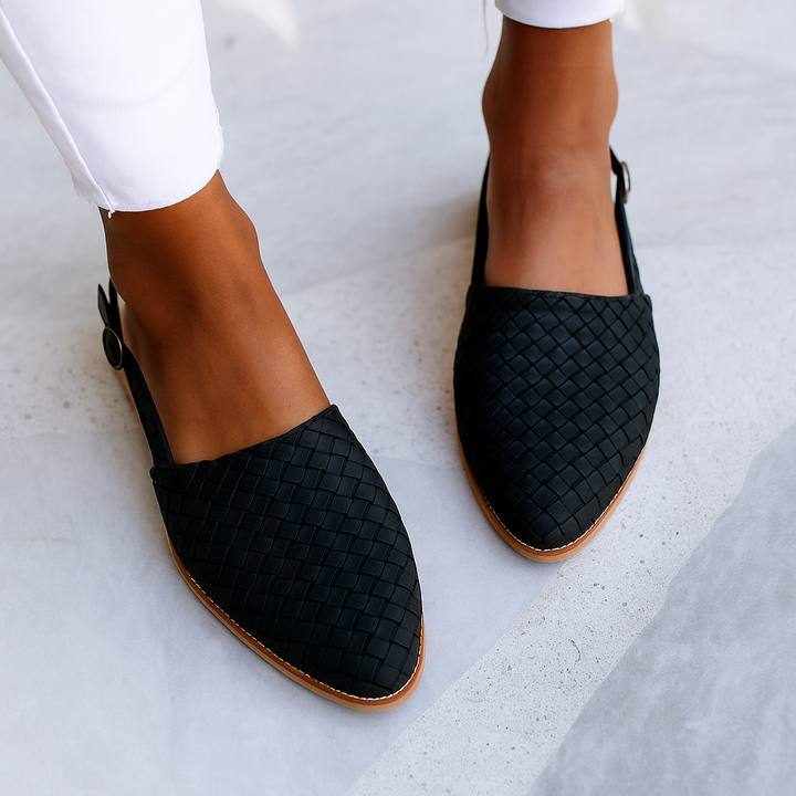 Black woven leather flat sandal featuring buckled slingback strap