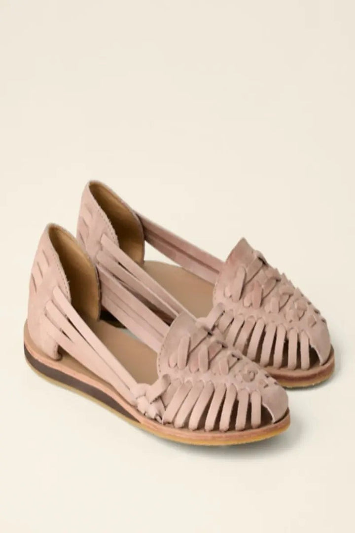 Blush suede woven huarache sandals featuring slip-on design and low wedge heel