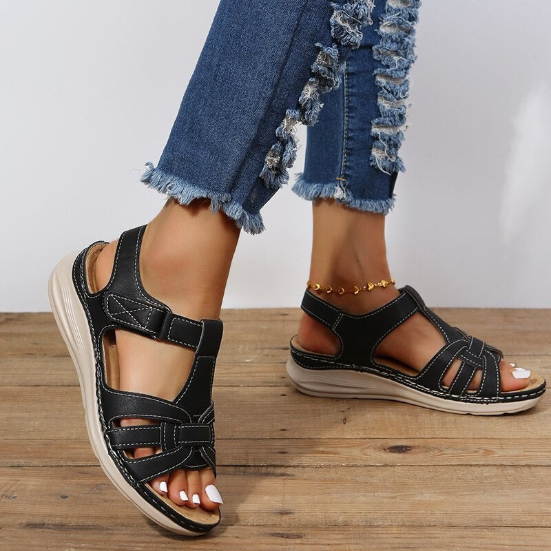 black woven strap sandals with ankle buckle and stitched wedge outsole