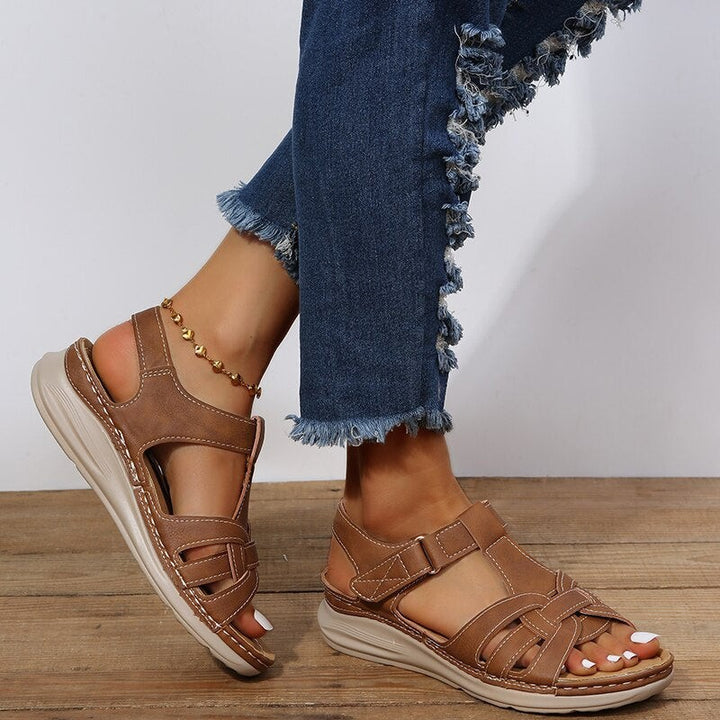 brown gladiator wedge sandals with cut-out detailing and cushioned insole