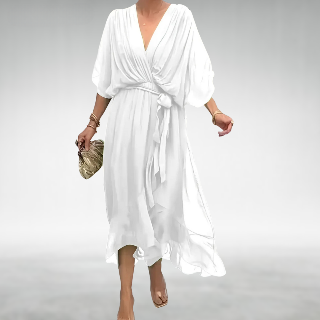 White flowing maxi dress with plunging wrap neckline and belted waist